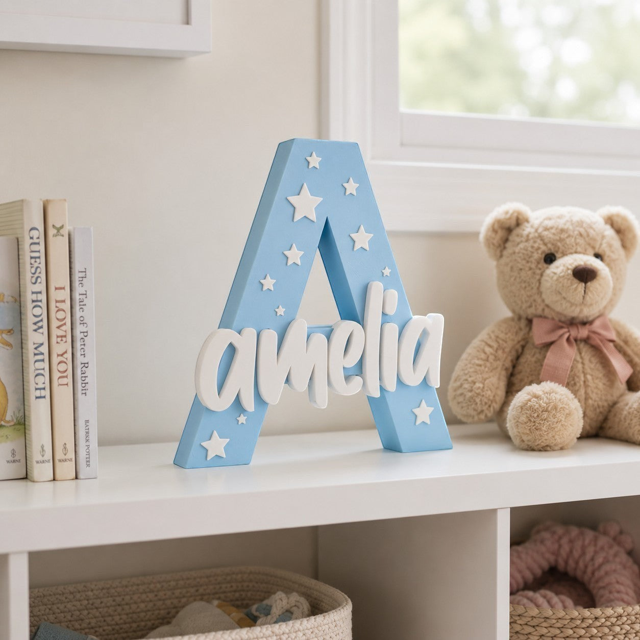 Stone Look Statues blue letter A nursery decor with white star accents and personalized name Amelia on a shelf