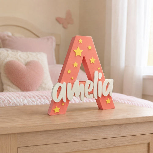 Stone Look Statues coral letter A nursery decor with white Amelia name and yellow star accents on a wooden dresser.