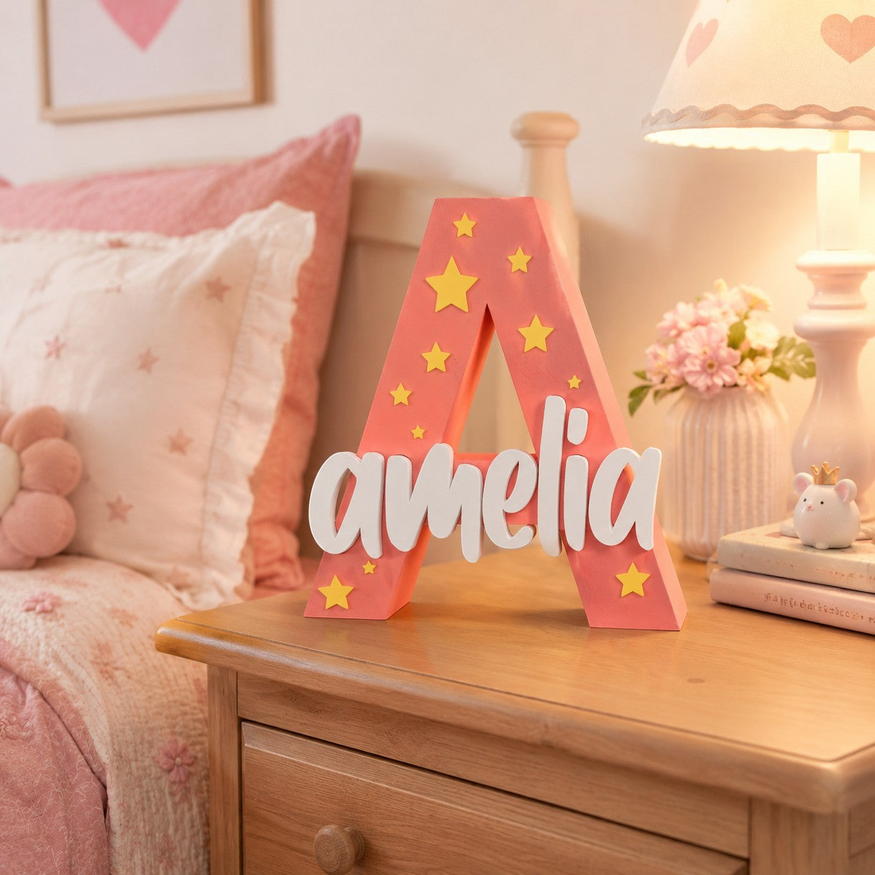 Stone Look Statues pink letter A nursery decor with yellow stars and white Amelia name cutout on a wooden nightstand